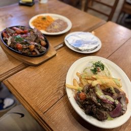 Ochos 888 signature dishes Lomo SaltadoSteak and NoodlesFlaming Parmesan Scallops